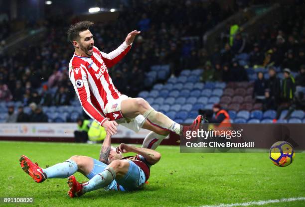 Geoff Cameron of Stoke City and Scott Arfield of Burnley clash in action during the Premier League match between Burnley and Stoke City at Turf Moor...