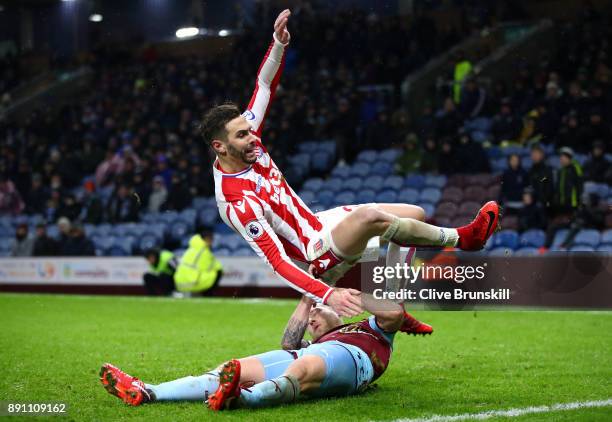 Geoff Cameron of Stoke City and Scott Arfield of Burnley clash in action during the Premier League match between Burnley and Stoke City at Turf Moor...