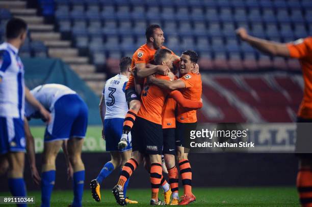 Fylde players celebrate after Danny L. Rowe scores during The Emirates FA Cup Second Round Replay match between Wigan Athletic and AFC Fylde at the...
