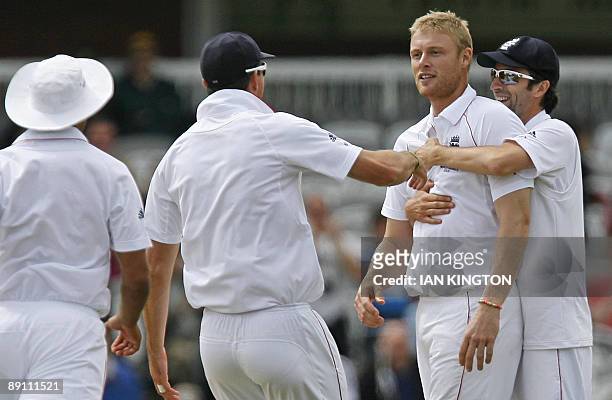 England's Andrew Flintoff celebrates the wicket of Australia's Brad Haddin for 80 runs with England's Graham Onions and team-mates during the...