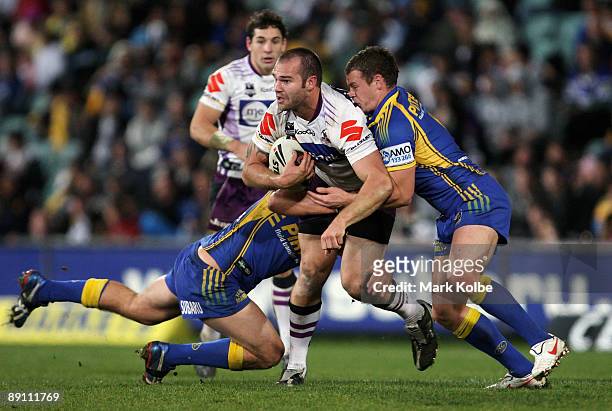 Scott Anderson of the Storm is tackled during the round 19 NRL match between the Parramatta Eels and the Melbourne Storm at Parramatta Stadium on...