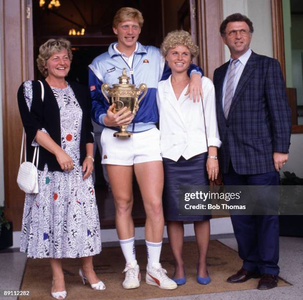 Boris Becker of Germany, with his mother Elvira, sister Sabine and father Karl-Heinz, holding the trophy after winning the men's singles final at the...