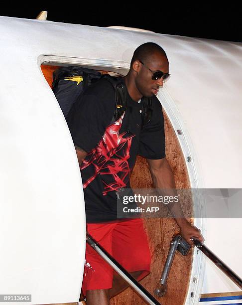 Basketball player Kobe Bryant of the Los Angeles Lakers disembarks from a plane shortly after arriving at the Manila international airport on July...