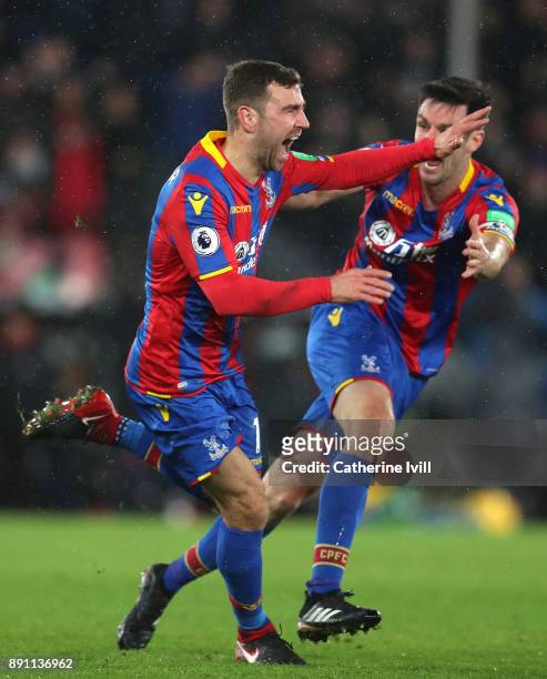 James McArthur of Crystal Palace celebrates after scoring his sides second goal with teammate Scott Dann during the Premier League match between...