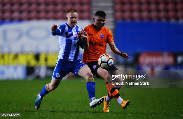 Jon Smith of AFC Fylde and David Perkins of Wigan Athletic in action during The Emirates FA Cup Second Round Replay match between Wigan Athletic and...