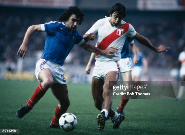 Dominique Rocheteau of France is challenged by Peru's Leguia during the International friendly match at the Parc Des Princes Stadium in Paris, 28th...