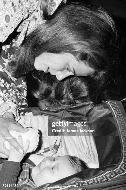 English actress Charlotte Rampling with her 8 month-old baby son Barnaby, at Heathrow Airport, London, 11th May 1973. Rampling, her son and her...