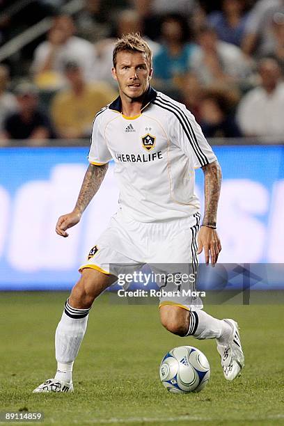 David Beckham of the Los Angeles Galaxy attacks the defense of AC Milan during the international friendly at The Home Depot Center on July 19, 2009...