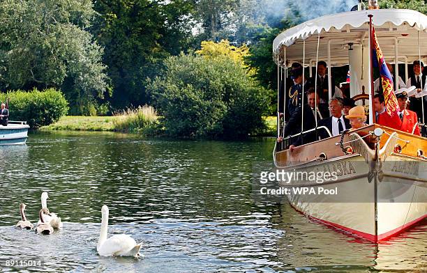 Queen Elizabeth II watches swans swim away from the steam launch 'Alaska' during a swan upping census on the River Thames on July 20, 2009 near...