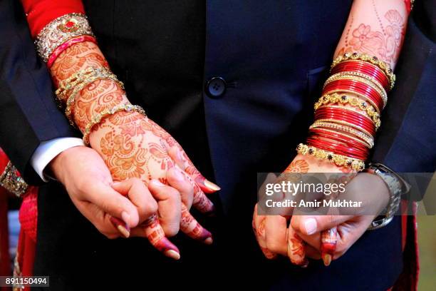 holding hands - pakistani gold jewelry stock pictures, royalty-free photos & images
