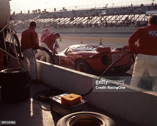 Mario Andretti makes a pit stop in the Luigi Chinetti Ferrari 512S during the 24 Hours of Daytona. Andretti had already won the Indy 500, Daytona...