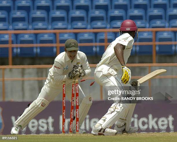 West Indies batsman David Bernard Jr is stumped by Bangladesh wicketkeeper Mushfiqur Rahim off Enamul Haque Jr for 69 runs on the fourth day of the...