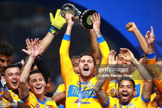 Andre Pierre Gignac of Tigres lifts the trophy to celebrate after winning the second leg of the Torneo Apertura 2017 Liga MX final between Monterrey...