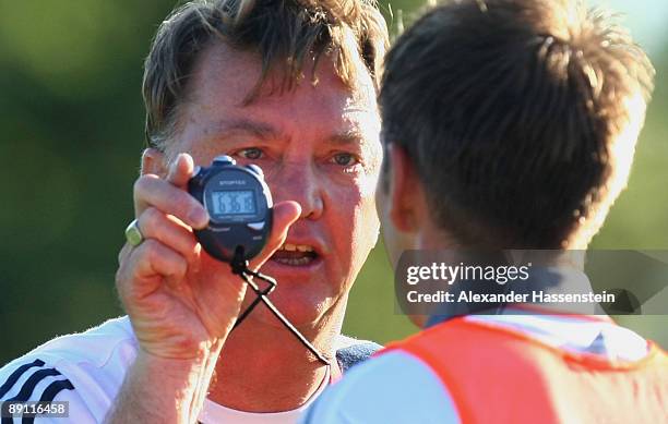 Louis van Gaal , head coach of Bayern Muenchen talks to his player Philipp Lahm during a training session at the Anton Mall stadium at day three of...