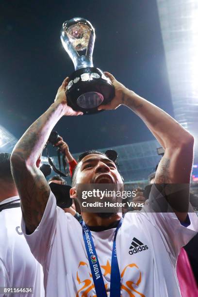 Javier Aquino of Tigres lifts the trophy to celebrate after winning the second leg of the Torneo Apertura 2017 Liga MX final between Monterrey and...