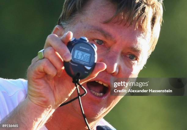 Louis van Gaal, head coach of Bayern Muenchen talks to his player during a training session at the Anton Mall stadium at day three of the FC Bayern...