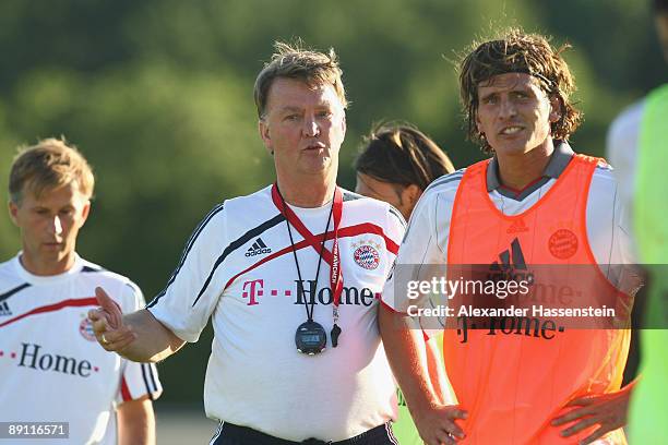 Louis van Gaal , head coach of Bayern Muenchen talks to his player Mario Gomez during a training session at the Anton Mall stadium at day three of...