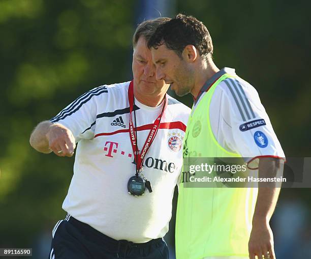 Louis van Gaal , head coach of Bayern Muenchen talks to his player Mark van Bommel during a training session at the Anton Mall stadium at day three...