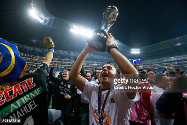 Juninho of Tigres lifts the trophy to celebrate after winning the second leg of the Torneo Apertura 2017 Liga MX final between Monterrey and Tigres...