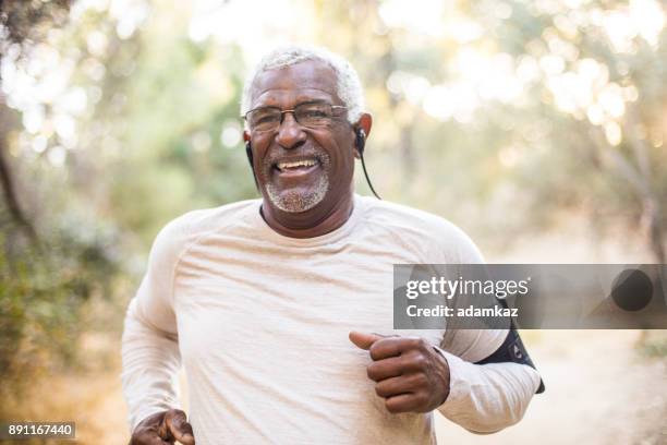 senior african american man jogging - male jogging stock pictures, royalty-free photos & images