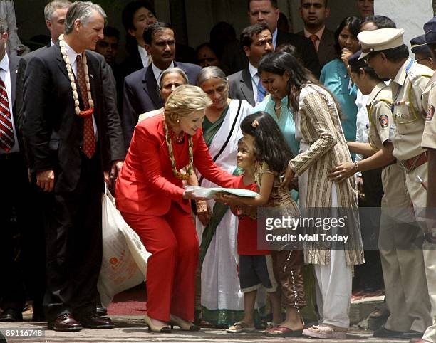 Secretary of State Hillary Clinton is welcomed by kids at the SEWA trade facilitation Center in Mumbai on Saturday, July 18, 2009.
