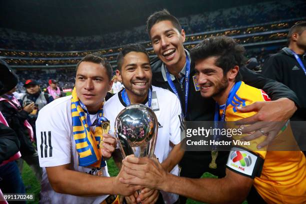 Juninho, Javier Aquino and Damon Alvarez of Tigres celebrate with the trophy after winning the second leg of the Torneo Apertura 2017 Liga MX final...