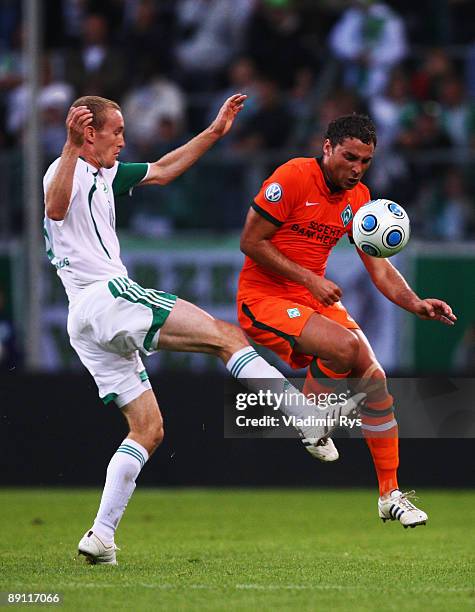 Thomas Kahlenberg of Wolfsburg and Dusko Tosic of Bremen battle for the ball during the Volkswagen Supercup final match between VfL Wolfsburg and SV...