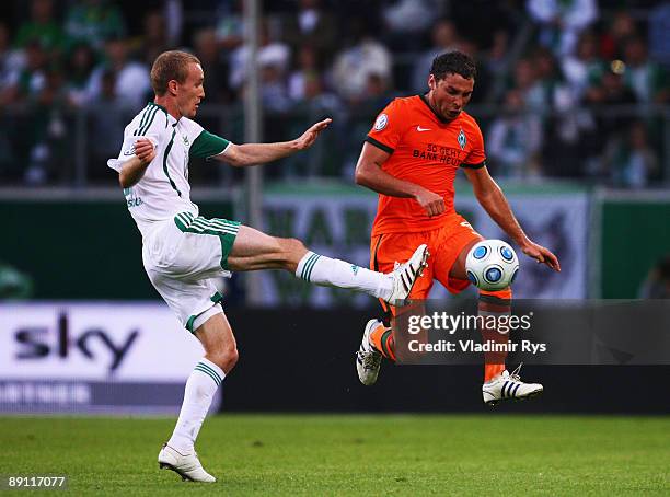 Thomas Kahlenberg of Wolfsburg and Dusko Tosic of Bremen battle for the ball during the Volkswagen Supercup final match between VfL Wolfsburg and SV...
