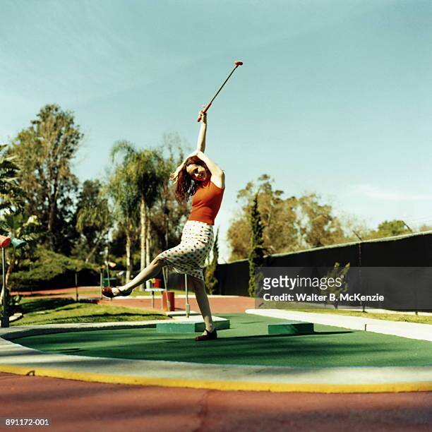 woman expressing joy on putting green at miniature golf course - mini golf stock pictures, royalty-free photos & images