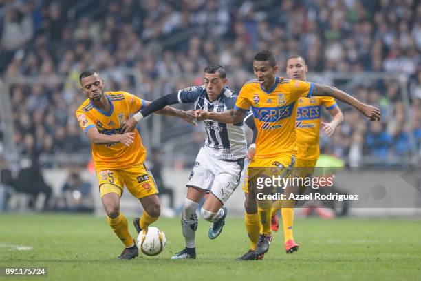 Rogelio Funes Mori of Monterrey fights for the ball with Rafael De Souza and Francisco Meza of Tigres during the second leg of the Torneo Apertura...