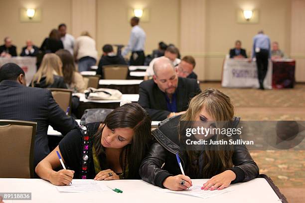 Job seekers Tiffany and Gianna fill out applications during a job fair for the adult entertainment industry July 20, 2009 in San Francisco,...