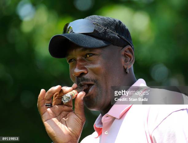 Five-time NBA MVP Michael Jordan smokes a cigar after hitting to the seventh green during the RBC Canadian Open's Mike Weir Charity Classic Pro-Am at...