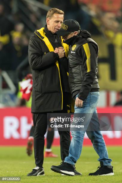Head coach Peter Stoeger of Dortmund and Co-coach Joerg Heinrich of Dortmund celebrate after winning the Bundesliga match between 1. FSV Mainz 05 and...