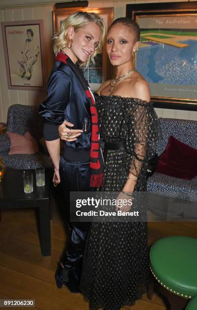 Poppy Delevingne and Adwoa Aboah attend the Love x Chaos x Poppy Delevingne x Moet Christmas Party at George on December 12, 2017 in London, England.