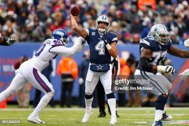 Dak Prescott of the Dallas Cowboys in action against Jason Pierre-Paul of the New York Giants on December 10, 2017 at MetLife Stadium in East...