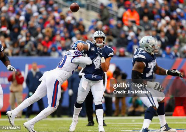 Dak Prescott of the Dallas Cowboys in action against Jason Pierre-Paul of the New York Giants on December 10, 2017 at MetLife Stadium in East...