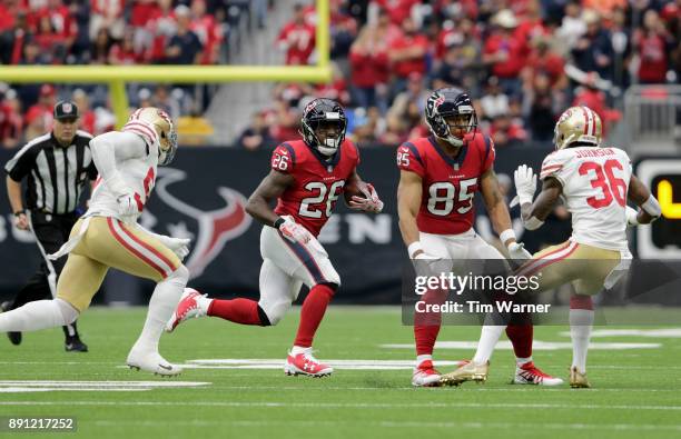 Lamar Miller of the Houston Texans carries the ball pursued by Reuben Foster of the San Francisco 49ers in the first quarter at NRG Stadium on...