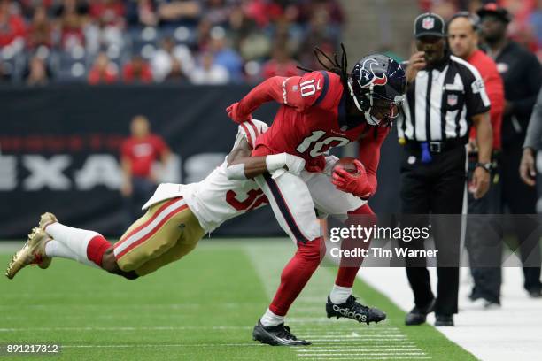 DeAndre Hopkins of the Houston Texans is tackled by Dontae Johnson of the San Francisco 49ers in the first quarter at NRG Stadium on December 10,...