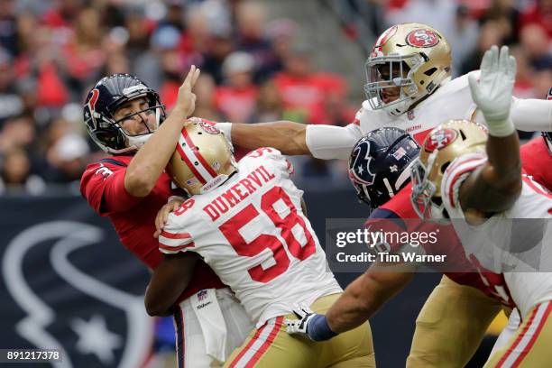 Tom Savage of the Houston Texans is hit by Elvis Dumervil of the San Francisco 49ers in the second quarter at NRG Stadium on December 10, 2017 in...