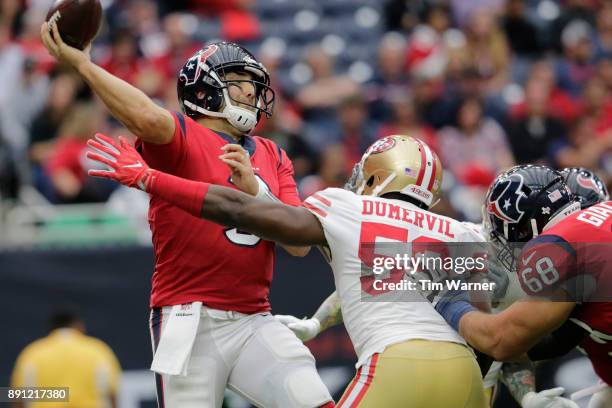 Tom Savage of the Houston Texans throws a pass under pressure by Elvis Dumervil of the San Francisco 49ers in the second quarter at NRG Stadium on...