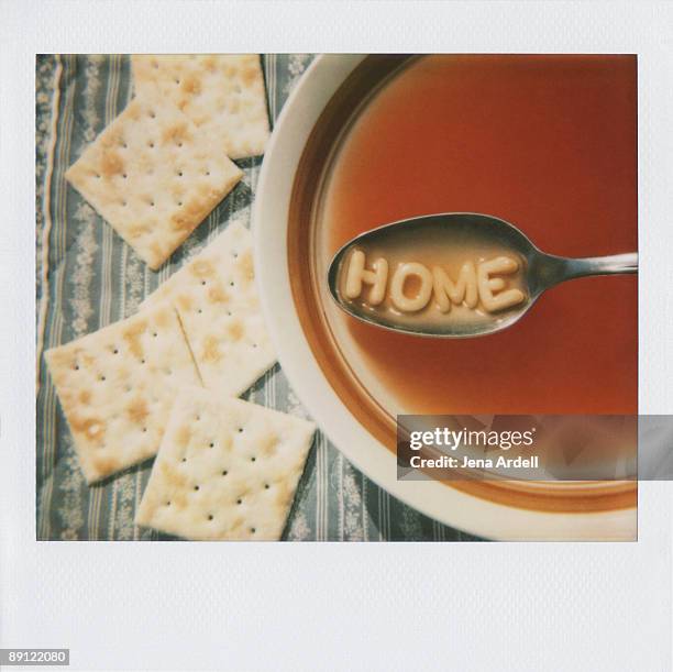 polaroid of alphabet soup spelling the word home - alphabet soup stock pictures, royalty-free photos & images