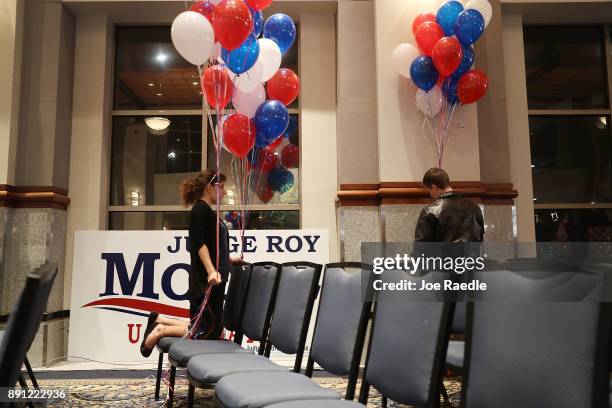 Katie Ford and Gabriel Burke put up balloons as they prepare the room for the arrival of Republican Senatorial candidate Roy Moore for his election...