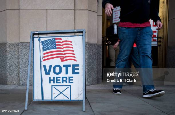 Voters exit the polling station at the Jefferson County Courthouse in Birmingham, Ala., on Tuesday, Dec. 12 after voting in the special election to...