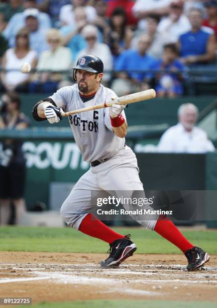 Jason Varitek of the Boston Red Sox tries to drag out a bunt during the MLB game against the Texas Rangers at Rangers Ballpark in Arlington on July...