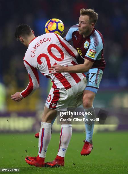 Scott Arfield of Burnley in action with Geoff Cameron of Stoke City during the Premier League match between Burnley and Stoke City at Turf Moor on...