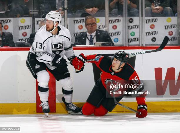 Kyle Clifford of the Los Angeles Kings checks Steven Santini of the New Jersey Devils during the first period at the Prudential Center on December...