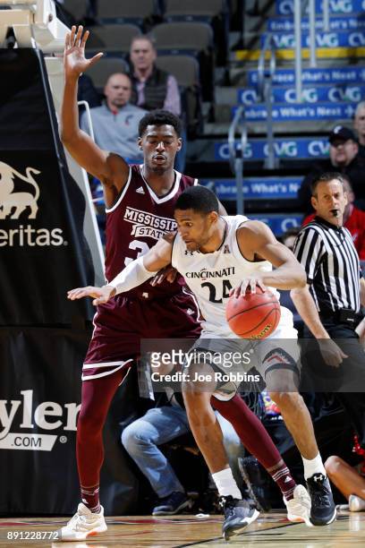 Kyle Washington of the Cincinnati Bearcats looks to the basket against Aric Holman of the Mississippi State Bulldogs in the first half of a game at...
