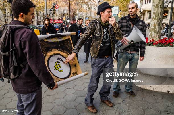 Protester points out a sign with the Euro symbol in reference to economic speculation on energy.Coinciding with the Summit in Paris, One Planet,...