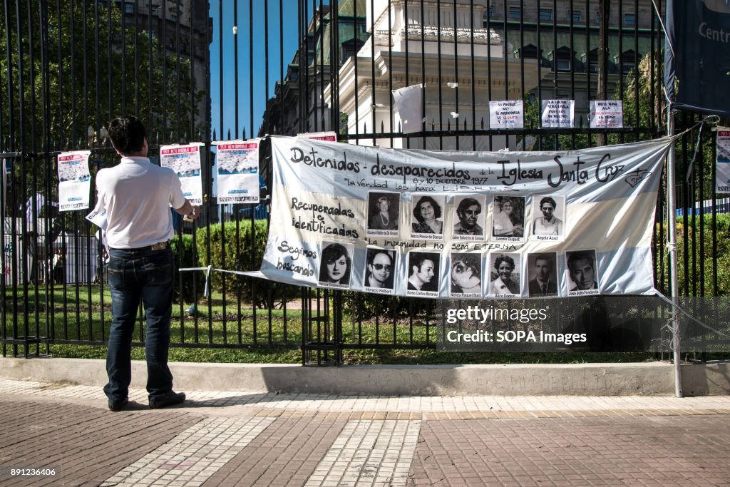 A spectator reads posters listing the names of disappeared...