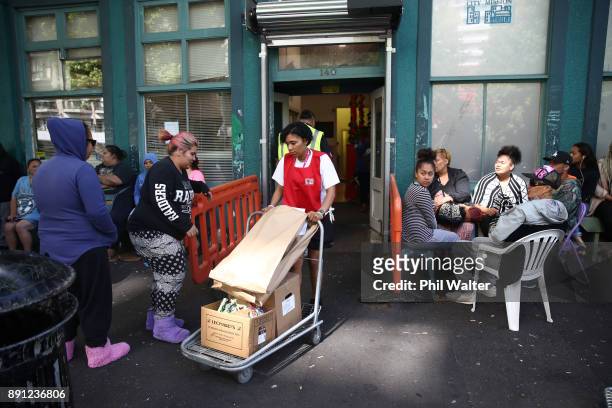 Auckland City Mission volunteers bring out parcels of food and presents for families over Christmas on December 13, 2017 in Auckland, New Zealand....
